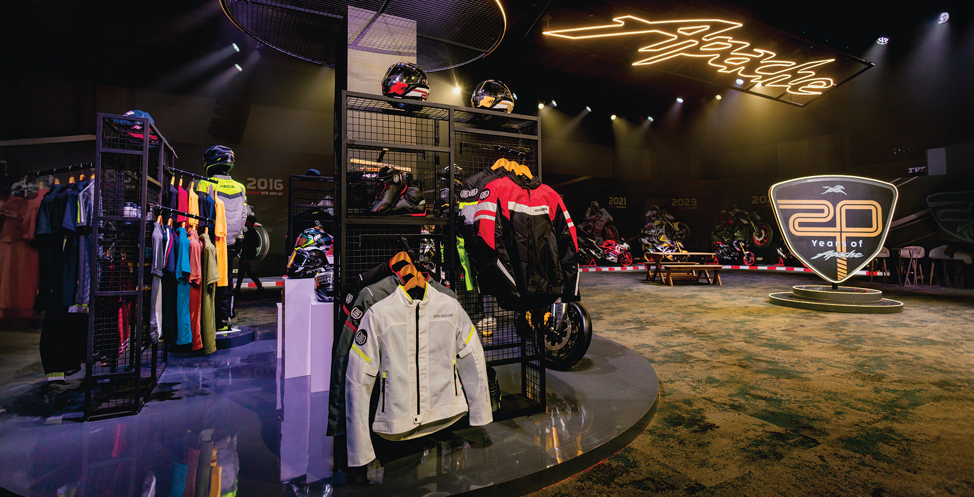 The 20 Years of Apache exhibition &mdash; riding gear, apparel and the Apache line-up displayed around an illuminated &lsquo;20 Years of Apache&rsquo; shield